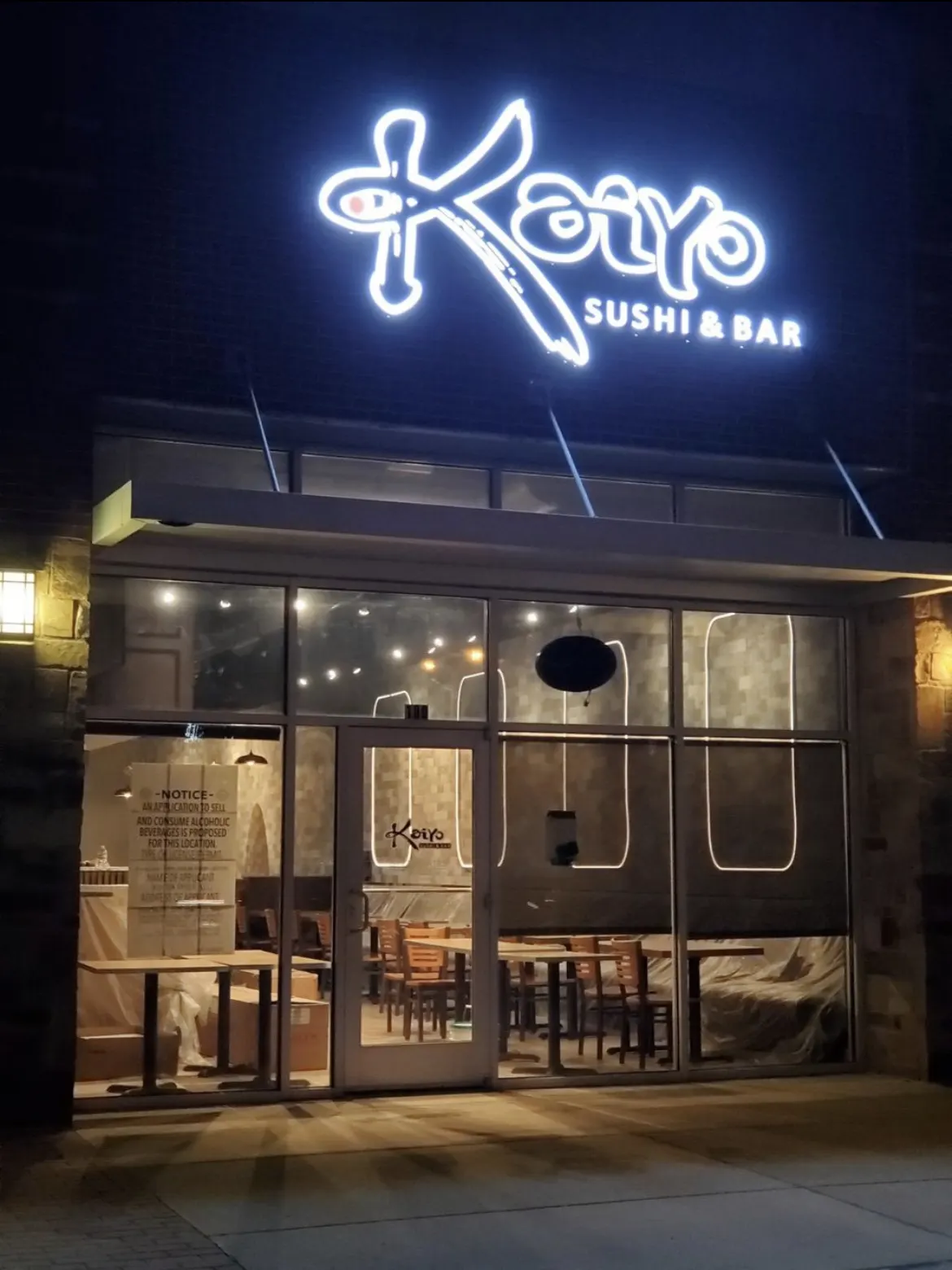 Kaiyo Sushi & Bar storefront lit at night after electrical build-out