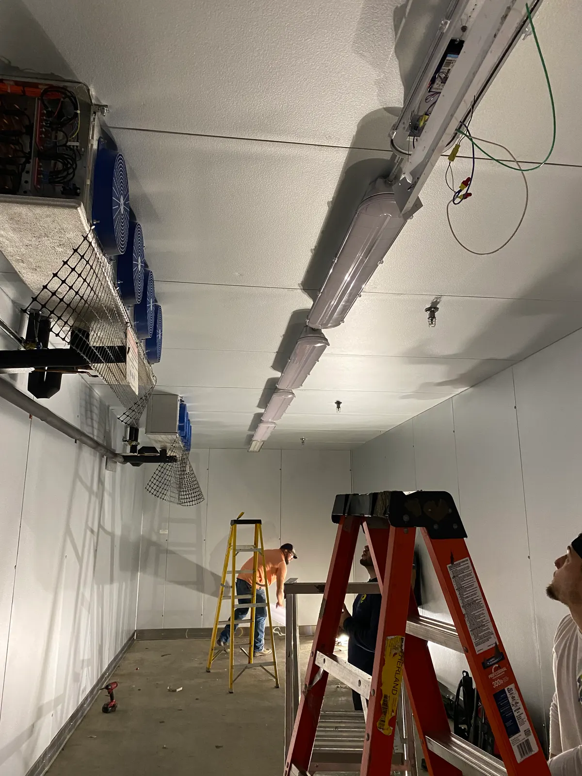 Walk-in cooler install: Lighting and refrigeration unit power inside a walk-in cooler.